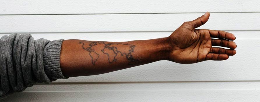 Arm with a tattoo of the world map